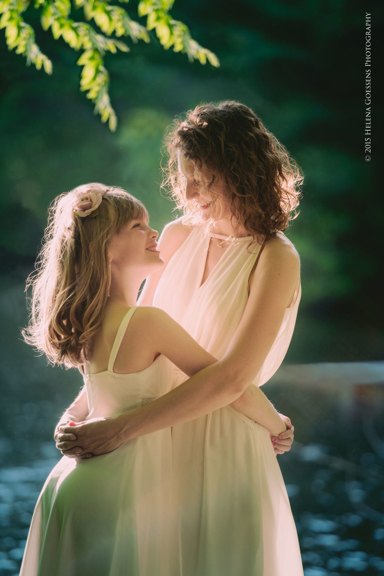Mother-Daughter photo session in white dresses holding each other in the woods