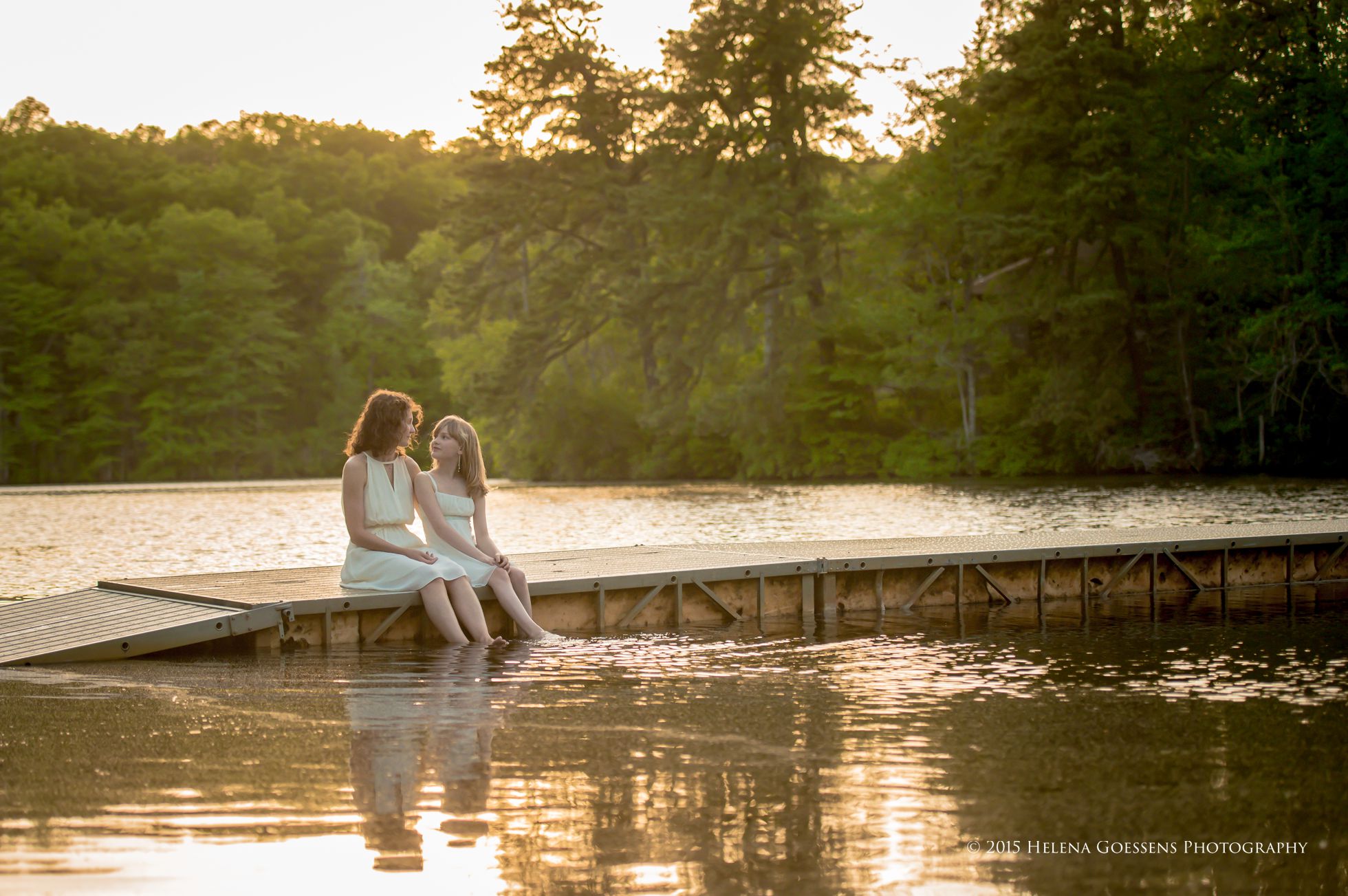 Mother-Daughter Photo Session sitting at the dock  with legs in the water