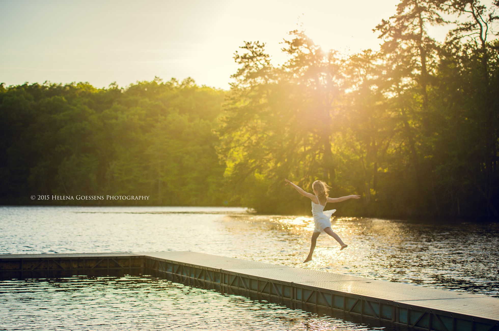 Girl jumping in a lake at sunset