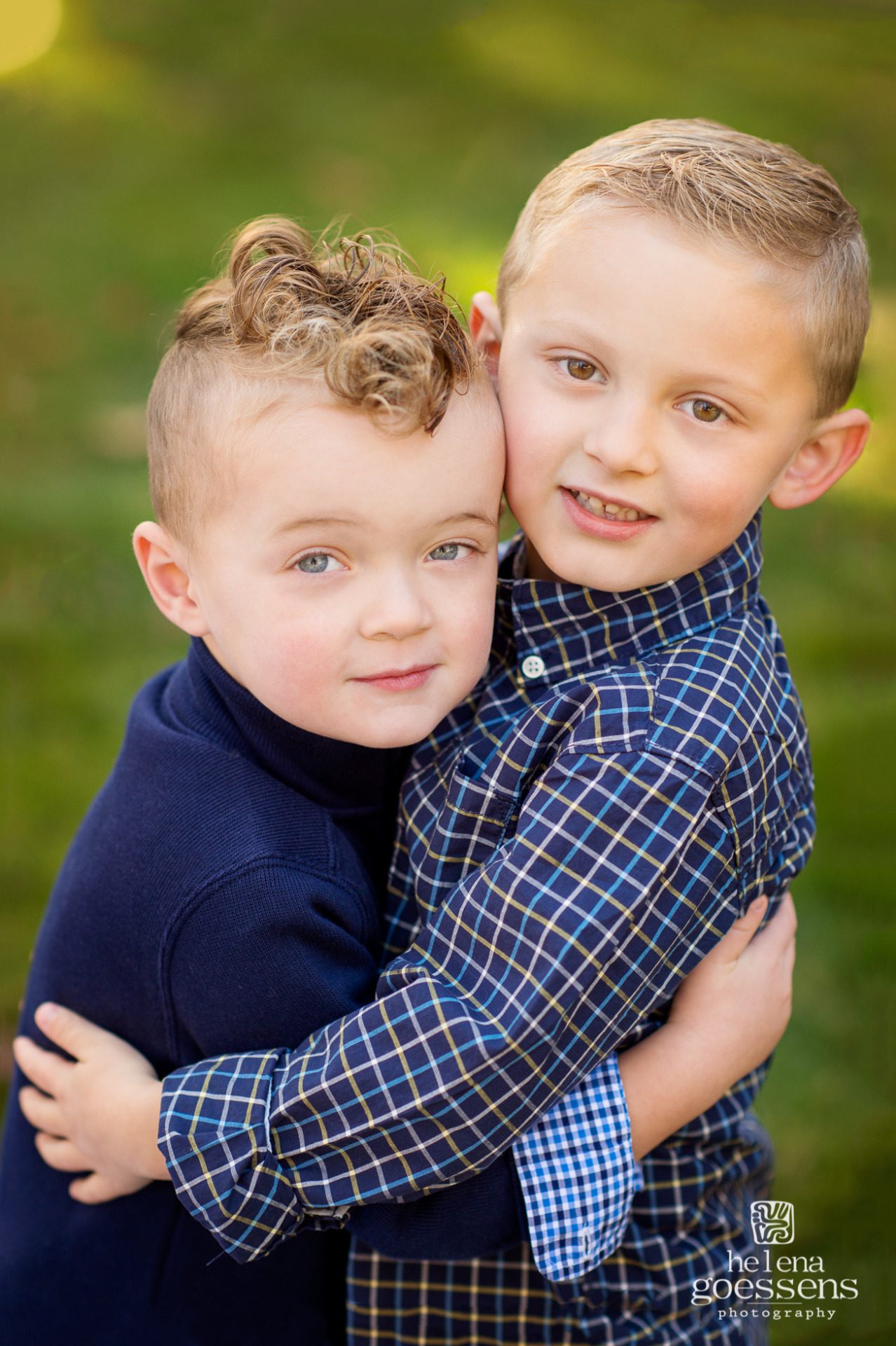 two boys holding each other with navy blue tops