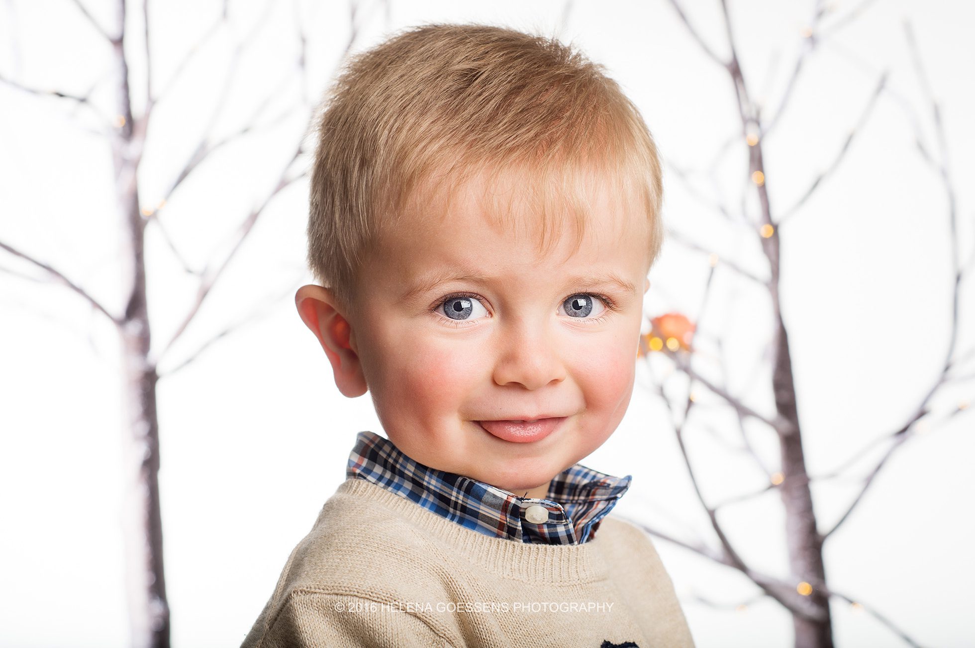 blond baby boy with blue eyes showing his tong