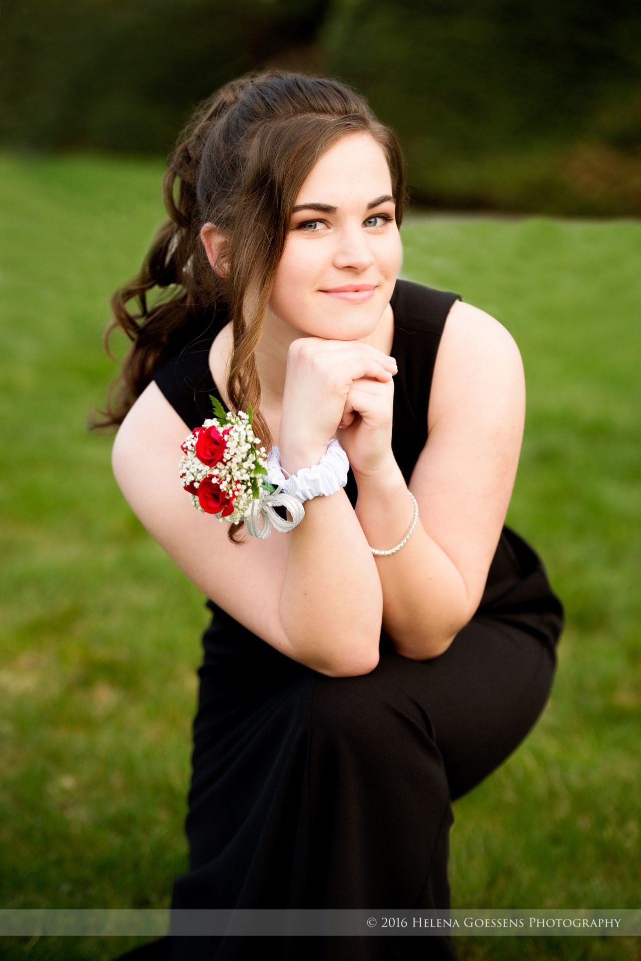 Brunette girl with green eyes and a red flowers corsage