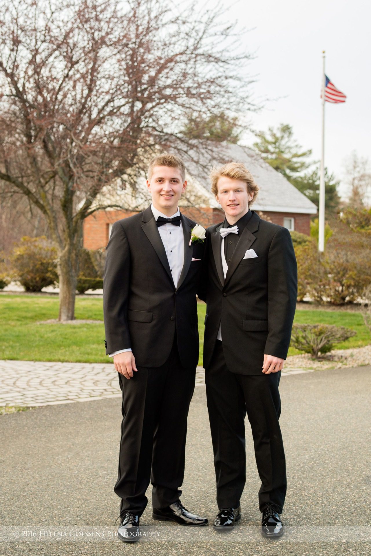 Two senior blond boys in black tuxedos