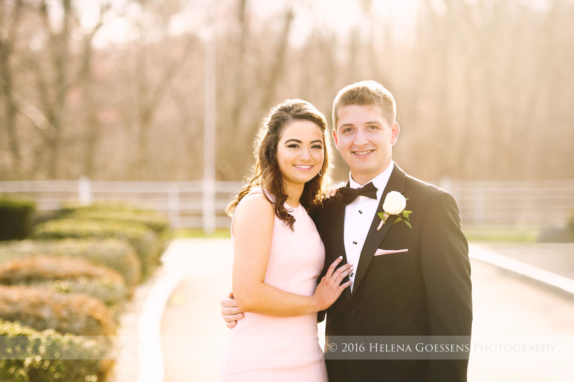 Prom girl wearing a pink dress and a boy in a tuxedo