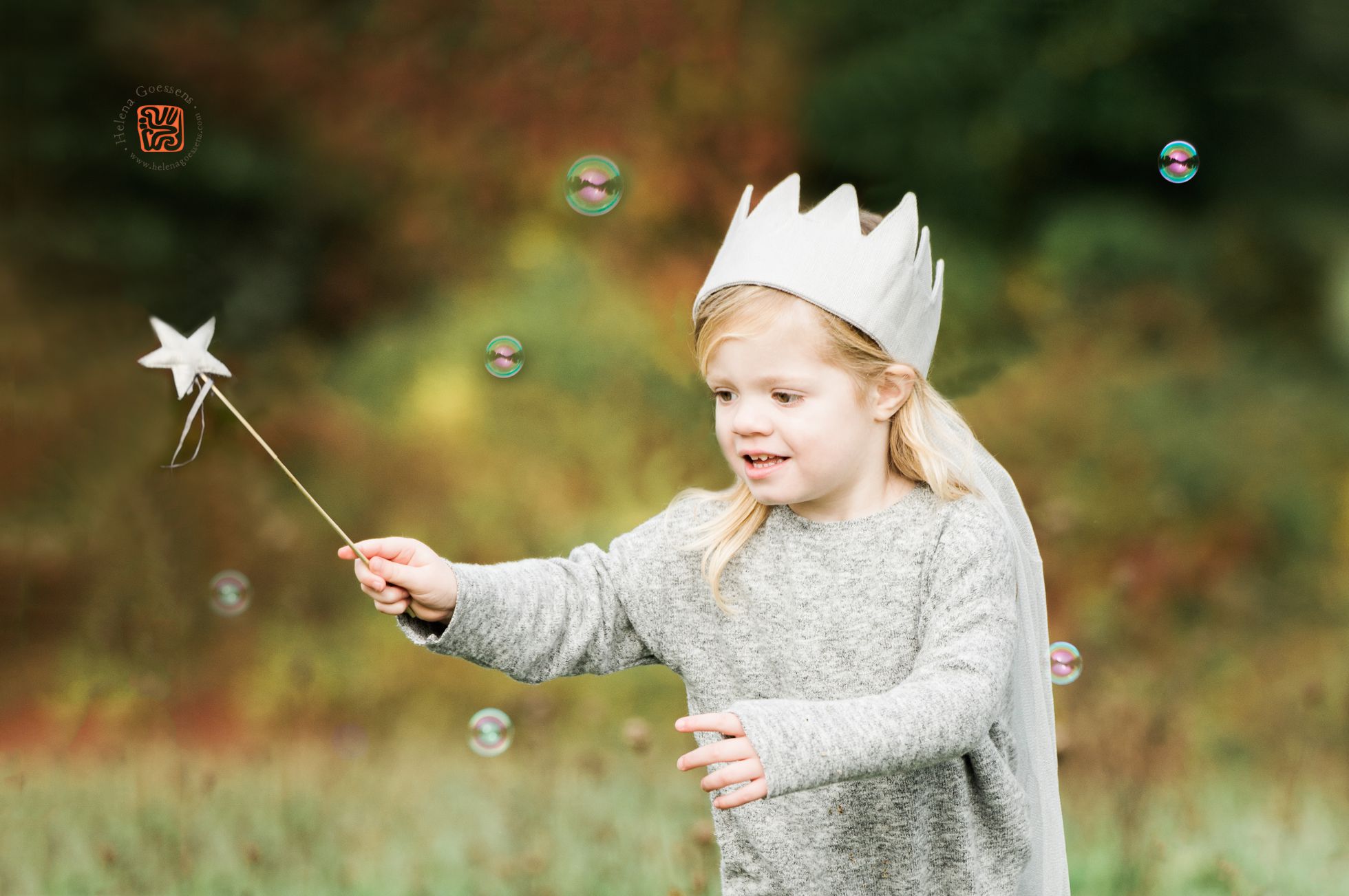 baby girl playing with a crown and bubbles