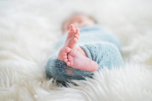 baby feet in a blue wrap