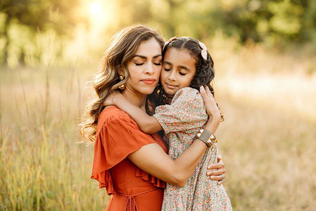 Mom and daughter with closed eyes hugging each other - Boston newborn and Family Photographer Helena Goessens Photography-Fall Family Sessions 2023