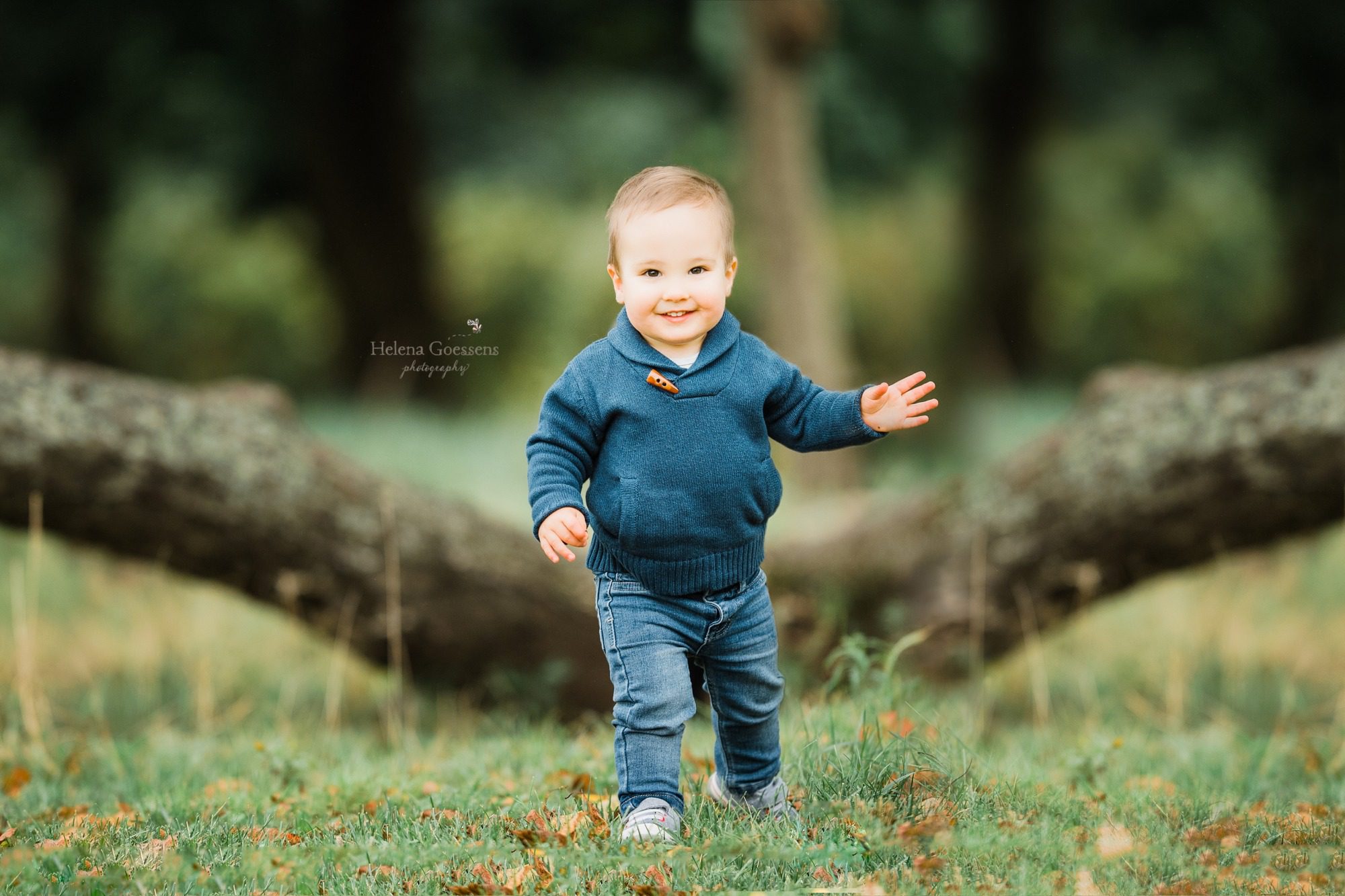 happy toddler runs around during family portraits with Helena Goessens