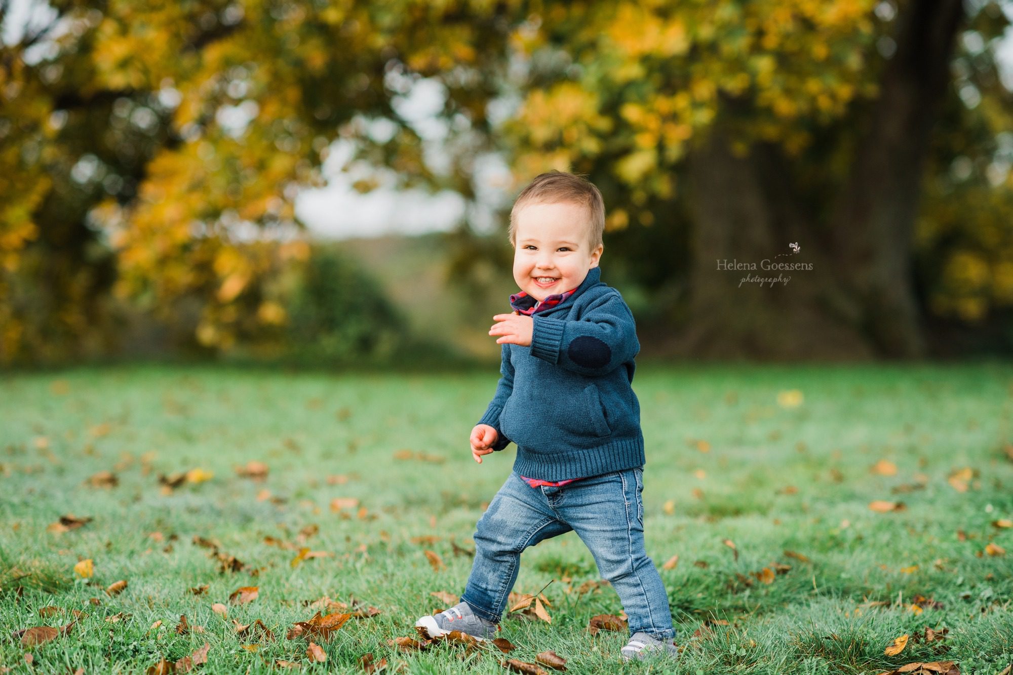 little boy plays during family pictures with Helena Goessens