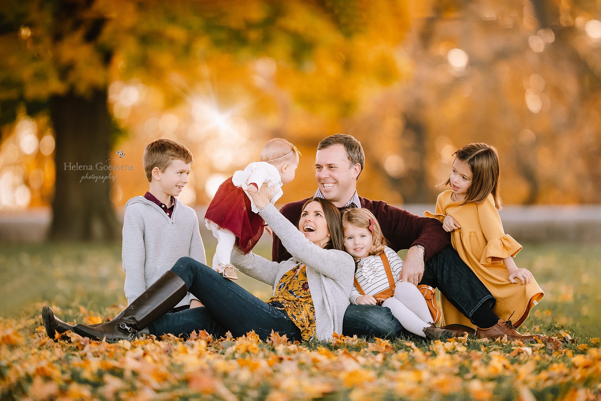 Family of 6 lying down in a fall afternoon