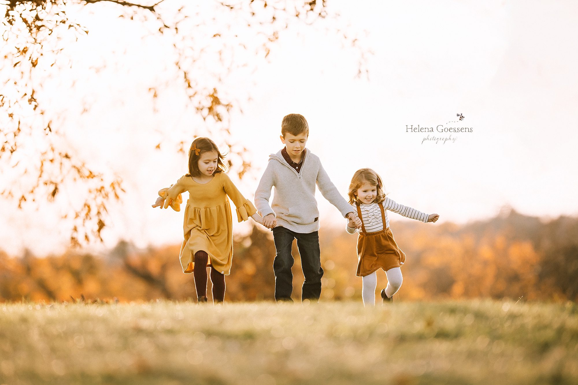 siblings run during family portraits with Boston MA family photographer Helena Goessens