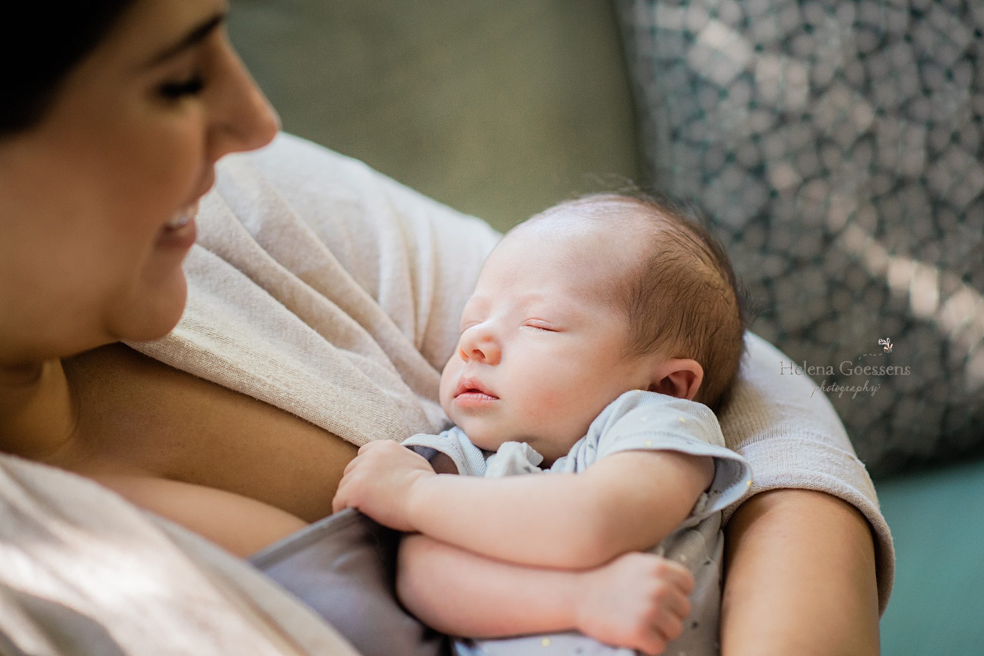 baby boy sleeps with mom during lifestyle newborn session by Helena Goessens