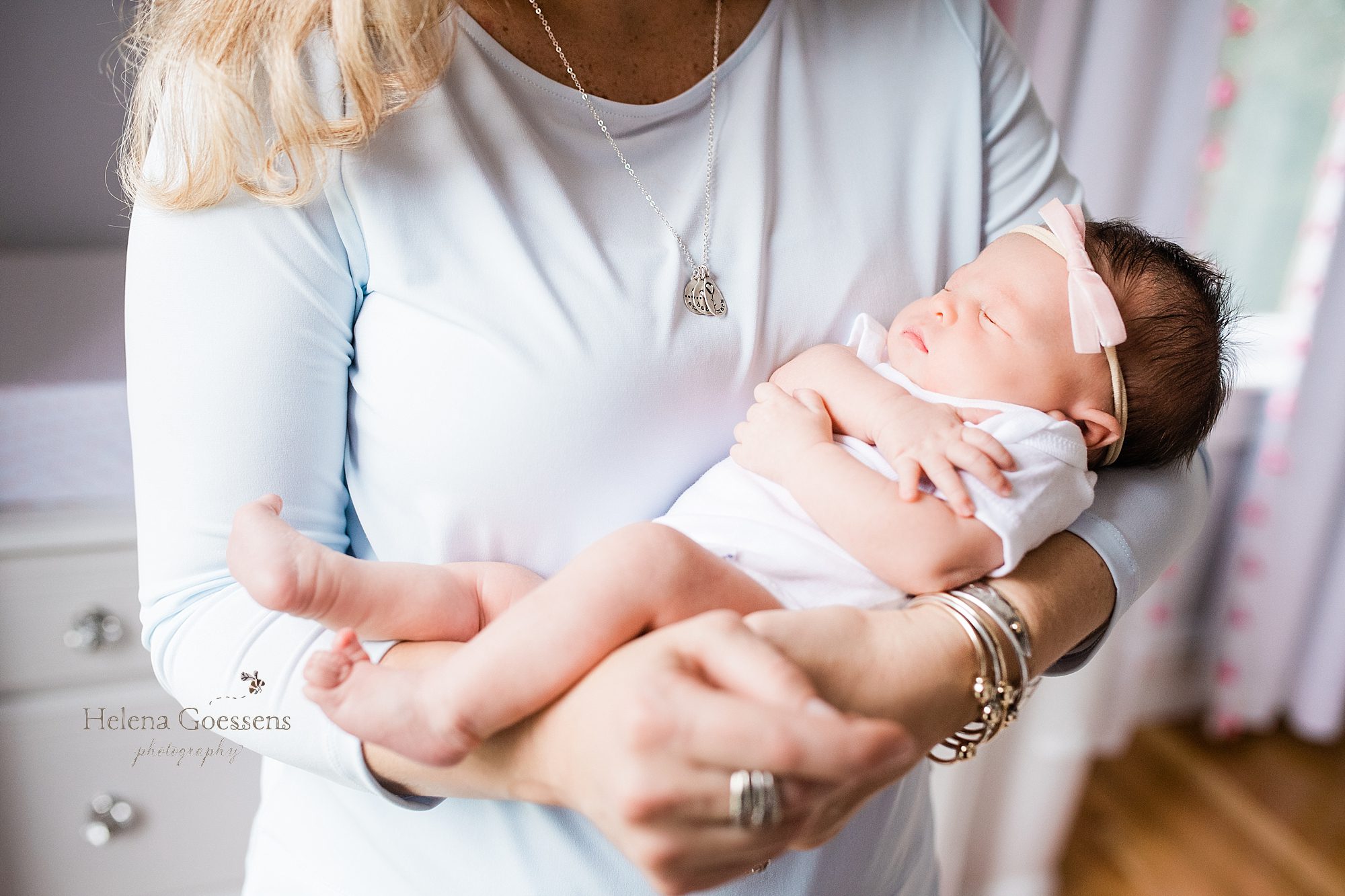 baby girl with mom during in home lifestyle newborn session Helena Goessens Photography