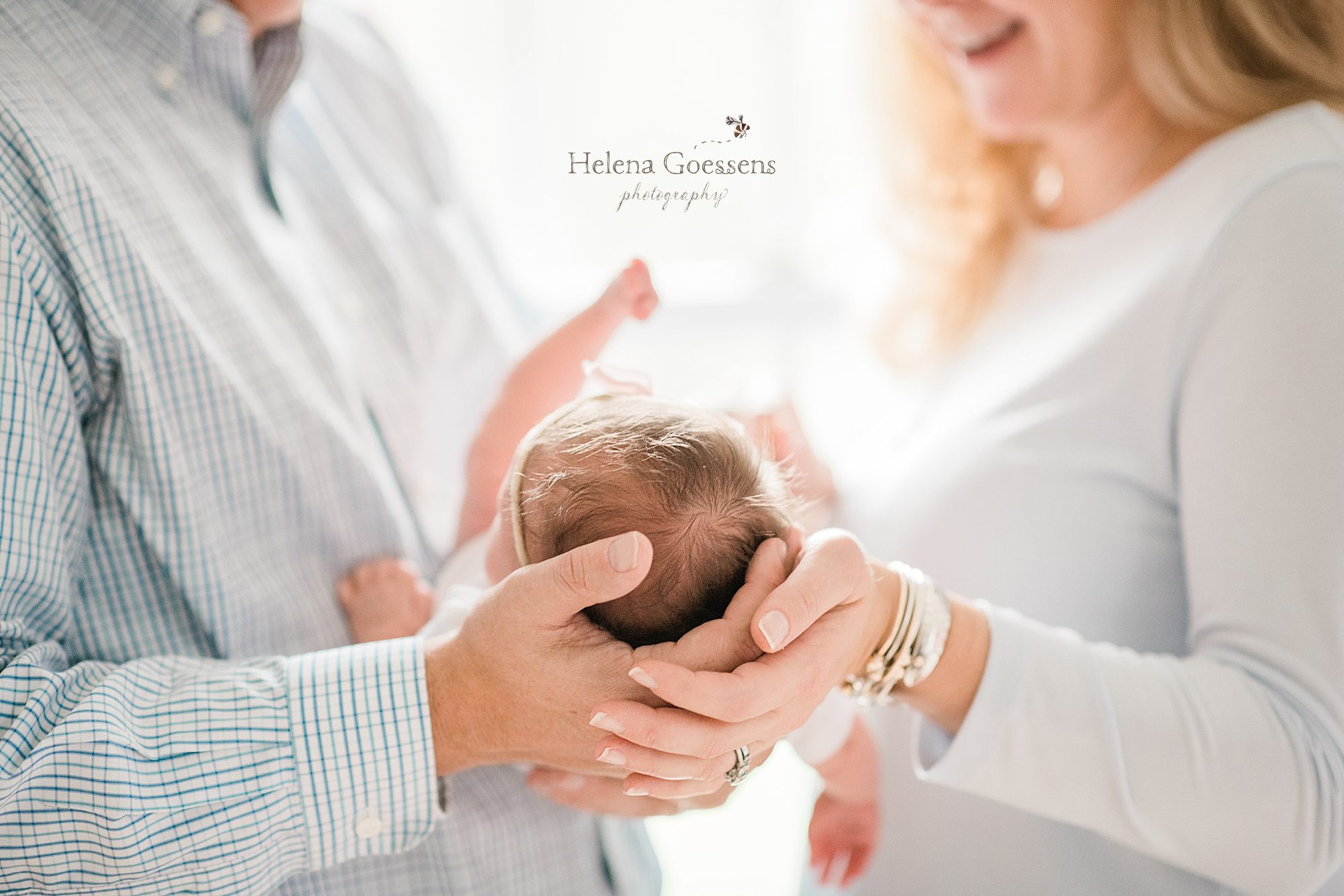 parents hold new baby girl during lifestyle session with Helena Goessens Photography