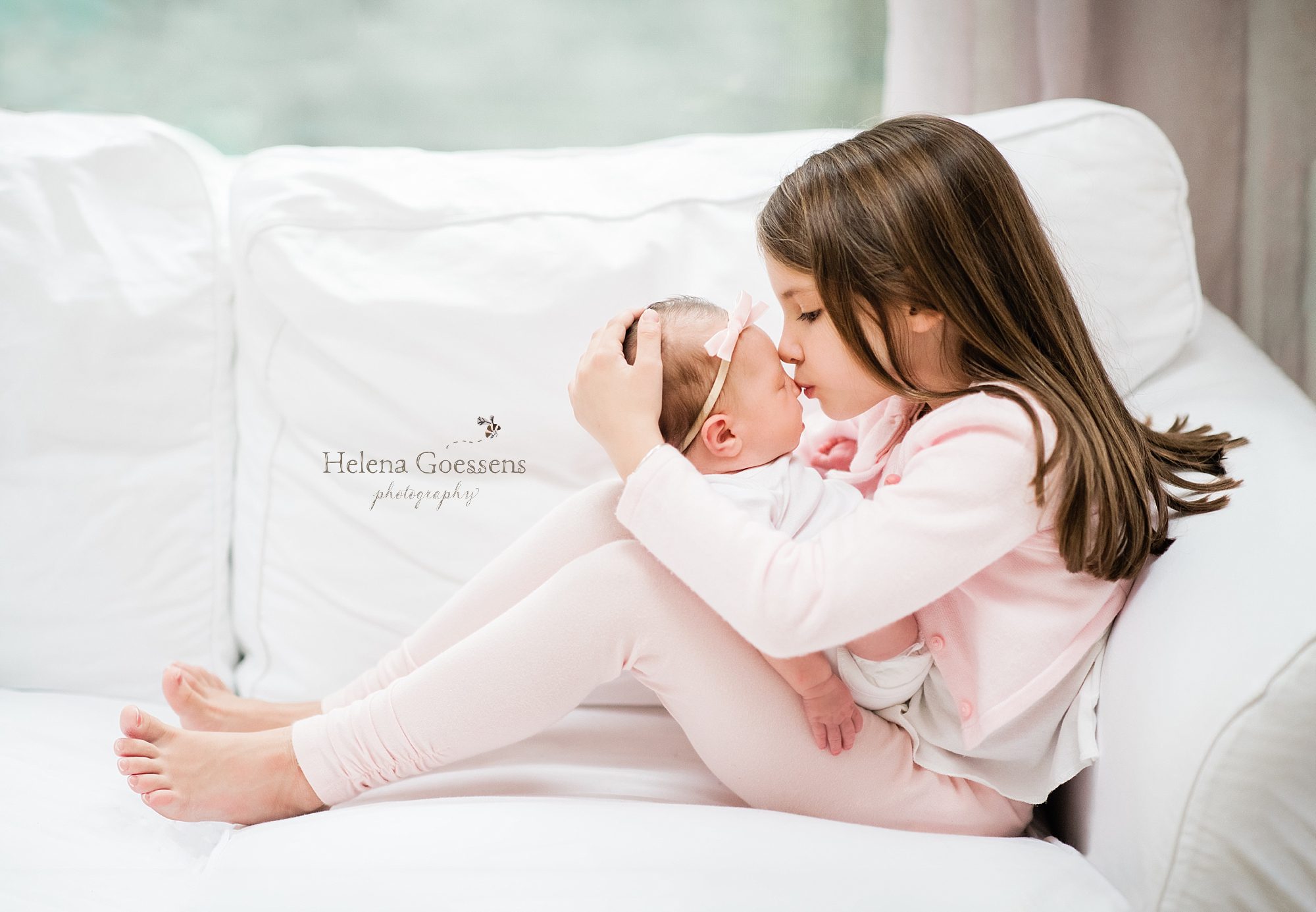 big sister holds newborn photographed by Helena Goessens Photography