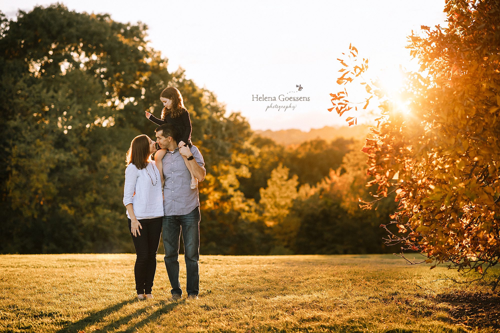 Family of three at a fall sunset