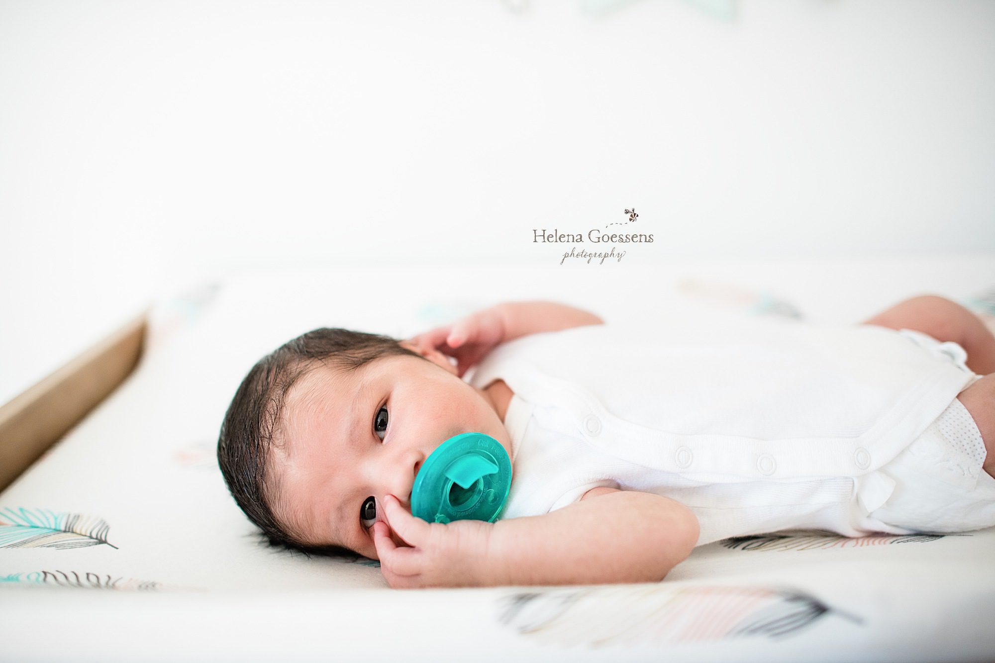 new baby boy with pacifier during in home lifestyle session with MA photographer Helena Goessens Photography