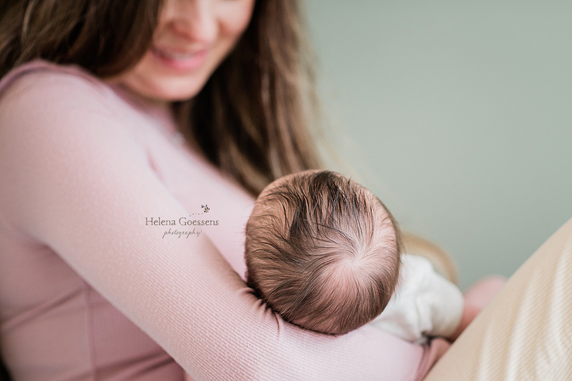 new mother holds daughter during lifestyle session with Helena Goessens Photography