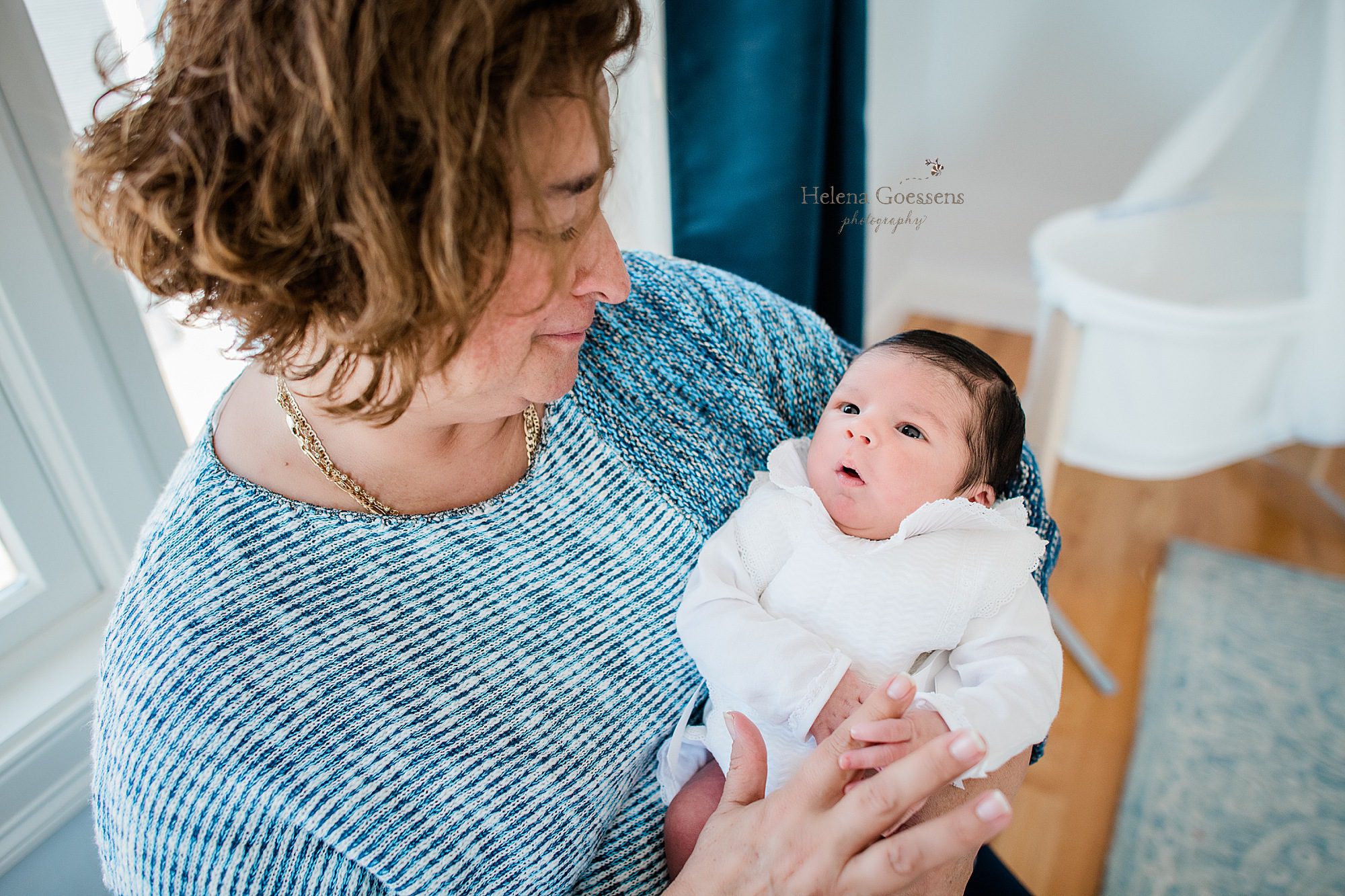 grandmother holds baby boy during lifestyle session with newborn photographer Helena Goessens Photography