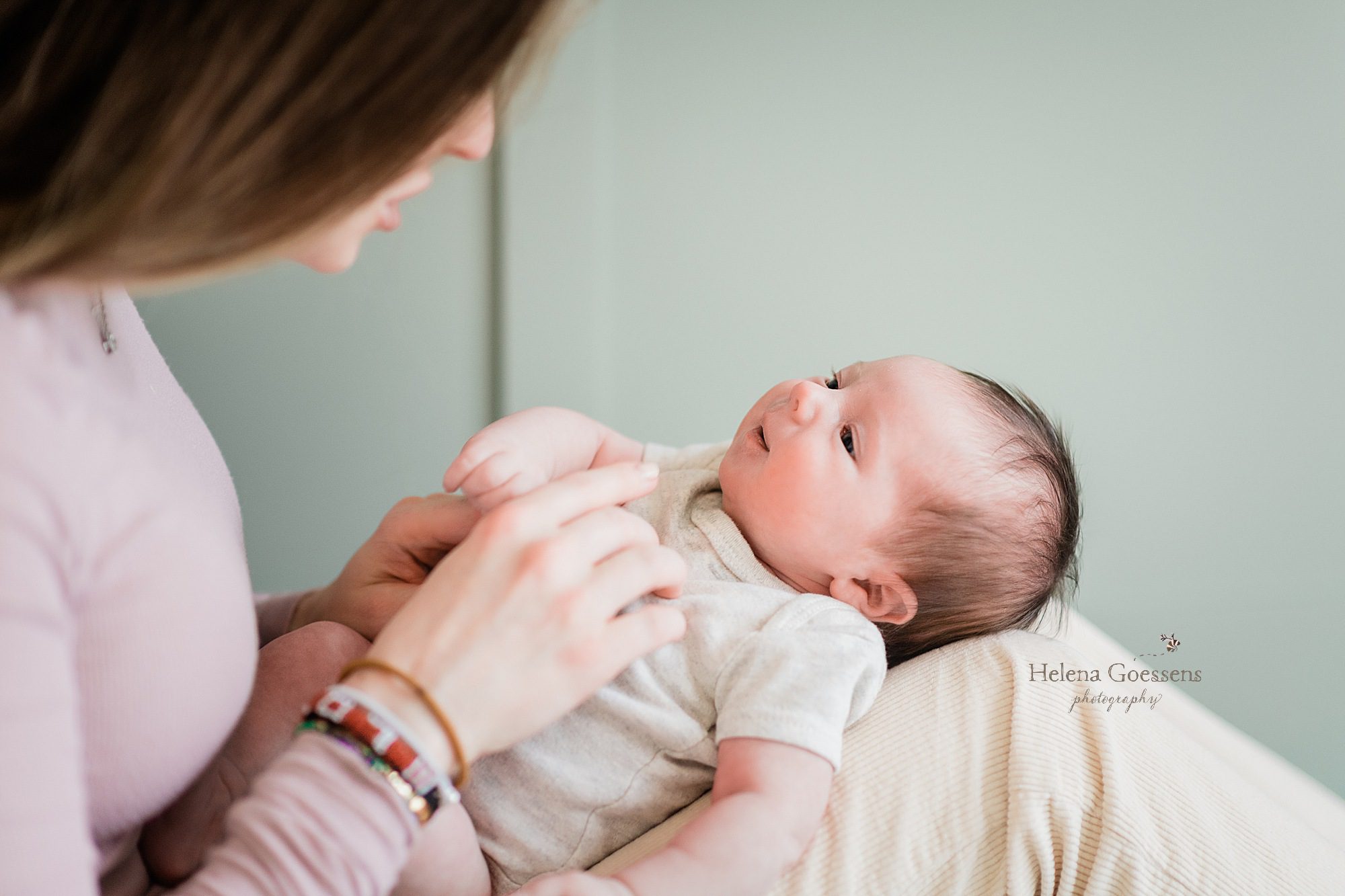 mom and daughter snuggle during newborn session with Helena Goessens Photography