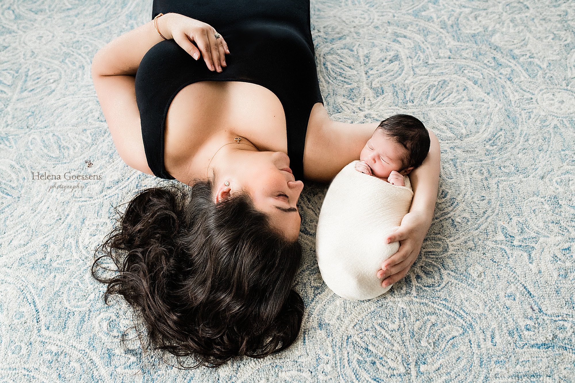 mother holds new baby during lifestyle session with Boston photographer Helena Goessens Photography