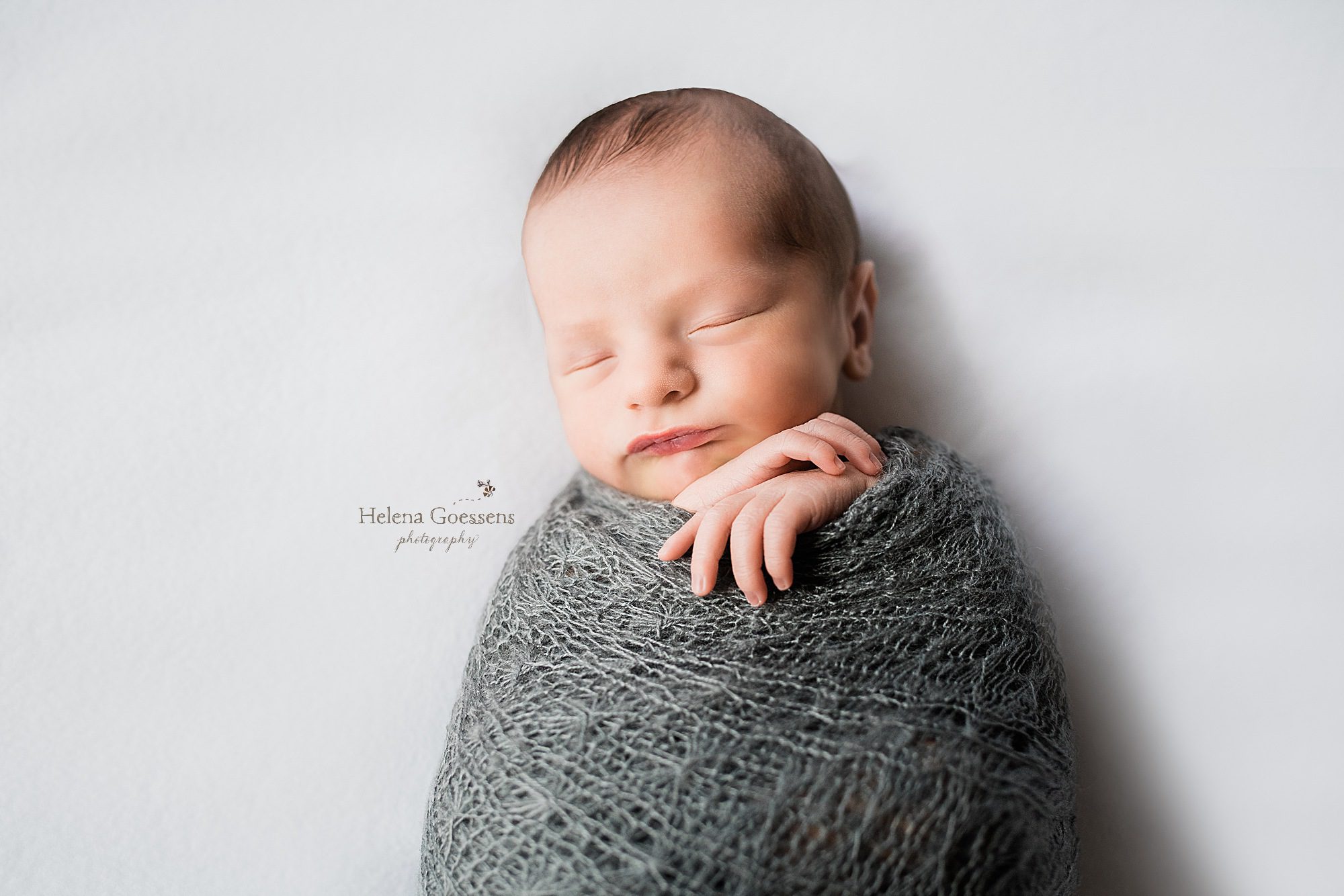 baby boy sleeps during newborn portraits with Helena Goessens Photography