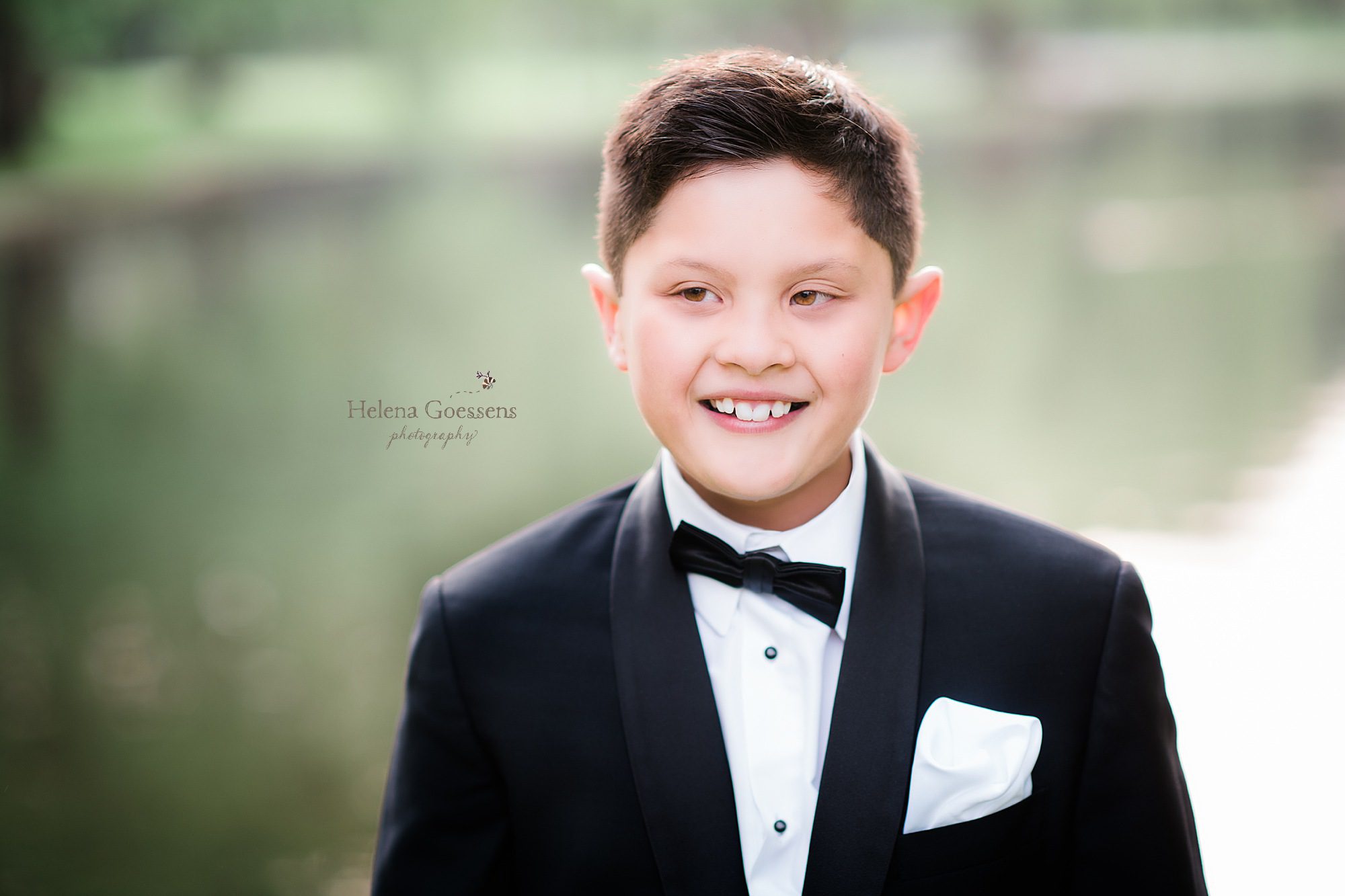 young man in tux during family portraits in Boston Public Gardens photographed by Helena Goessens Photography