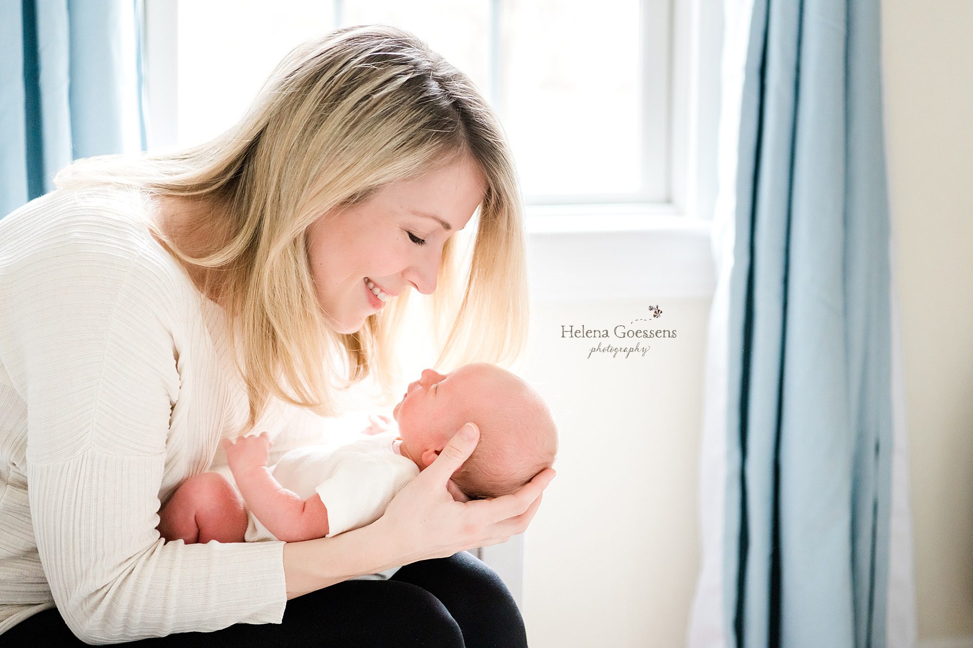 new mother holds son photographed by MA newborn photographer Helena Goessens Photography