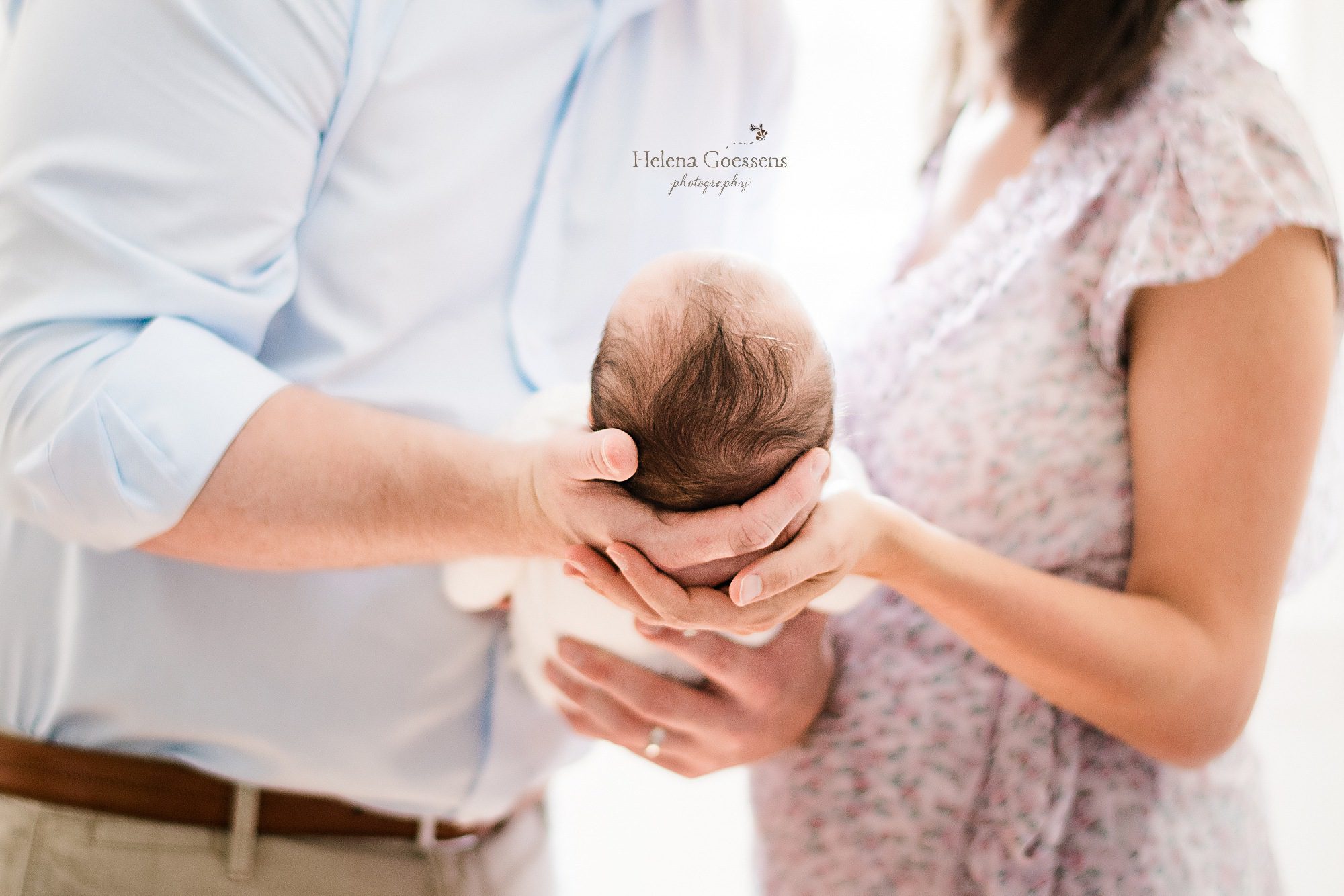 parents hold new baby girl photographed by Helena Goessens Photography