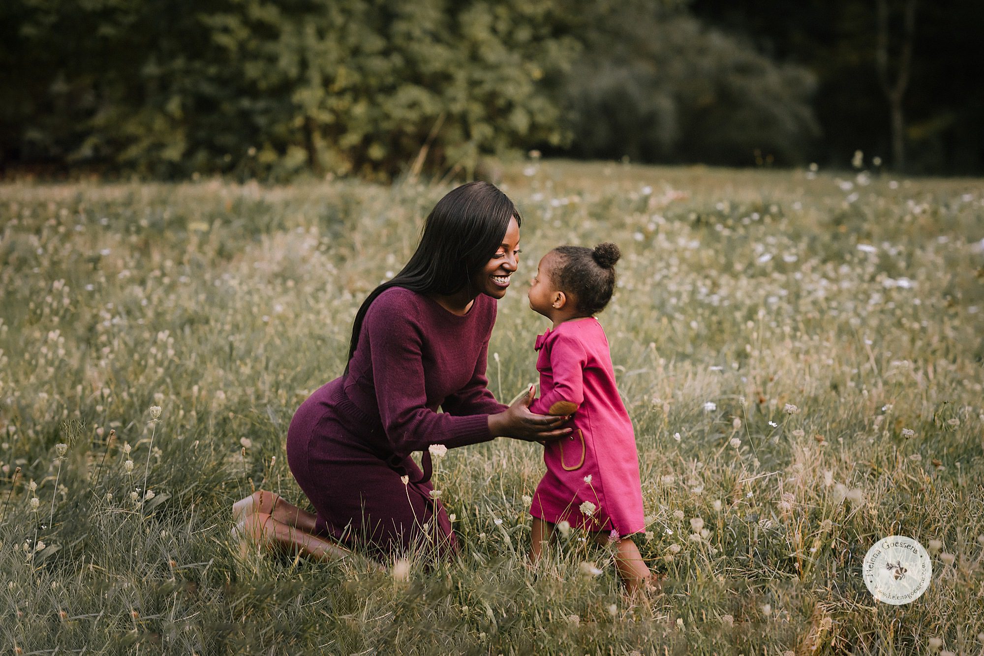 mother and daughter play during family photos by Helena Goessens Photography
