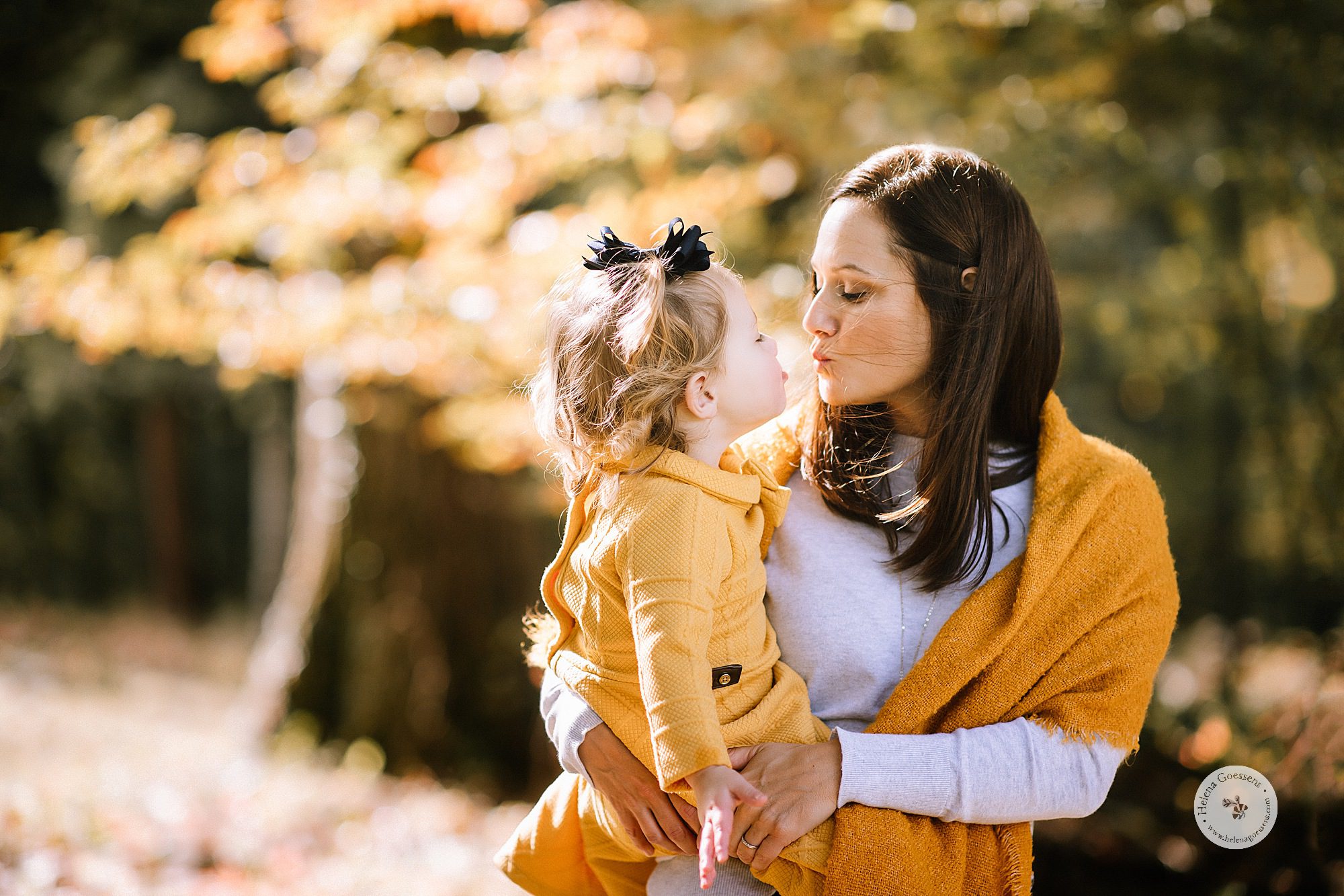 mother and daughter cuddle during fall family photos at the Bradley Estate with Helena Goessens Photography