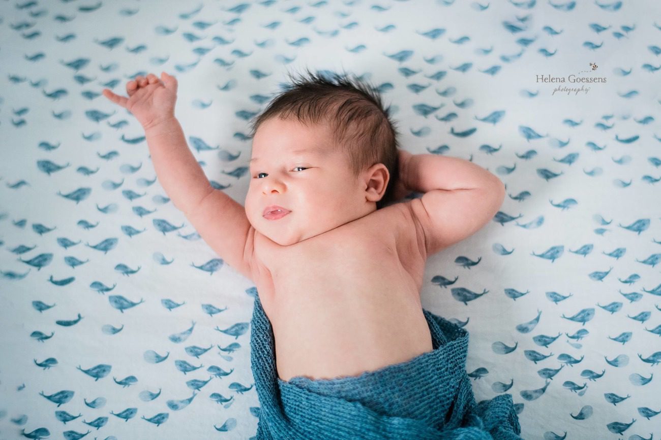 baby boy stretches during Needham MA newborn session with Helena Goessens Photography