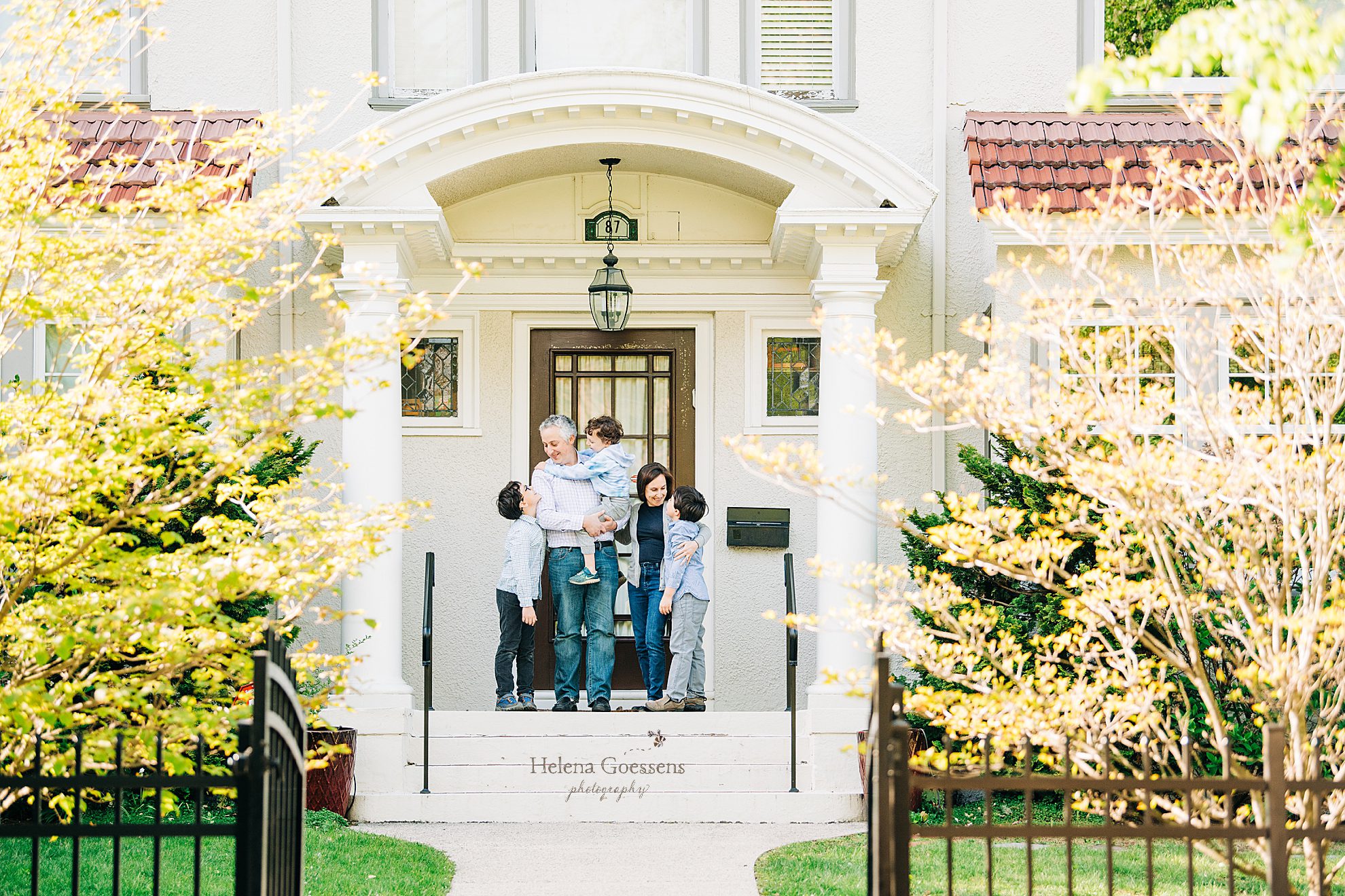 family poses on Front steps for Helena Goessens Photography