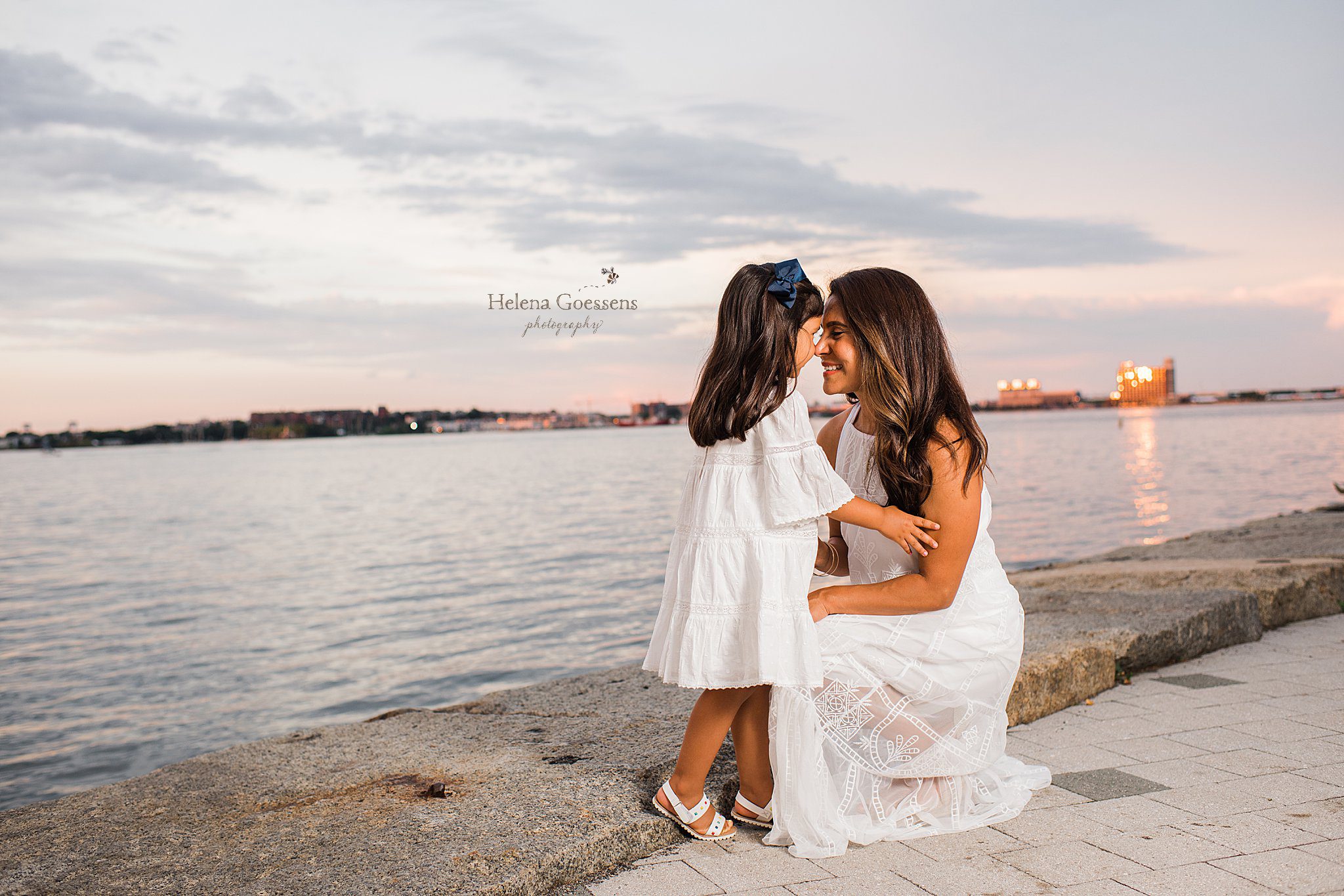 mom and daughter in white summer dresses pose during Fan Pier Boston Family Session