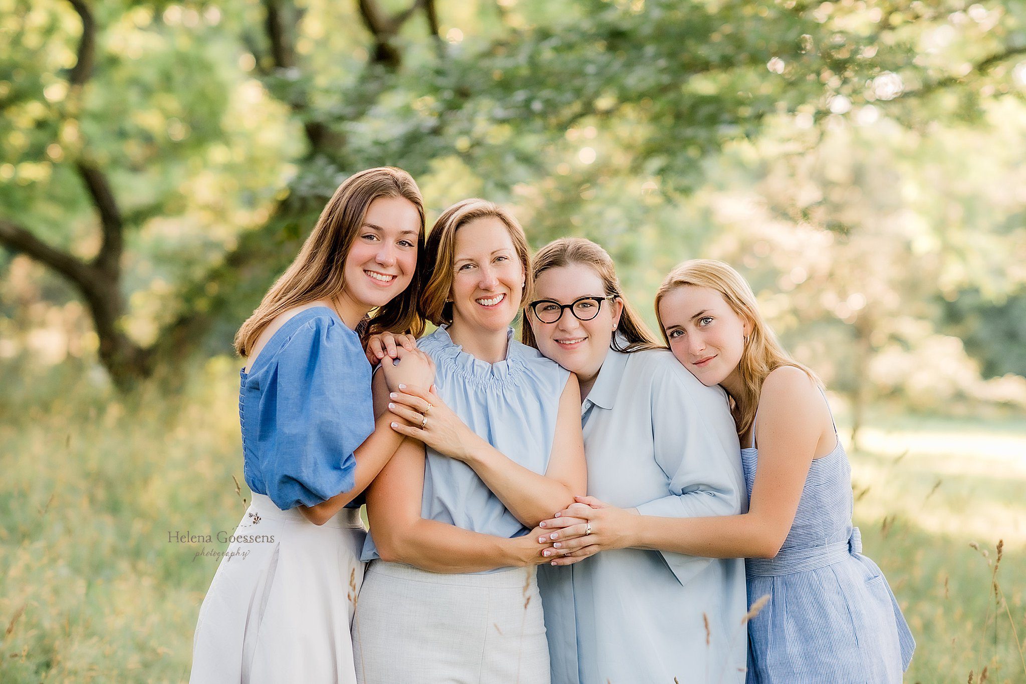 mom and daughters hold hands during family portraits at Peter's Hill