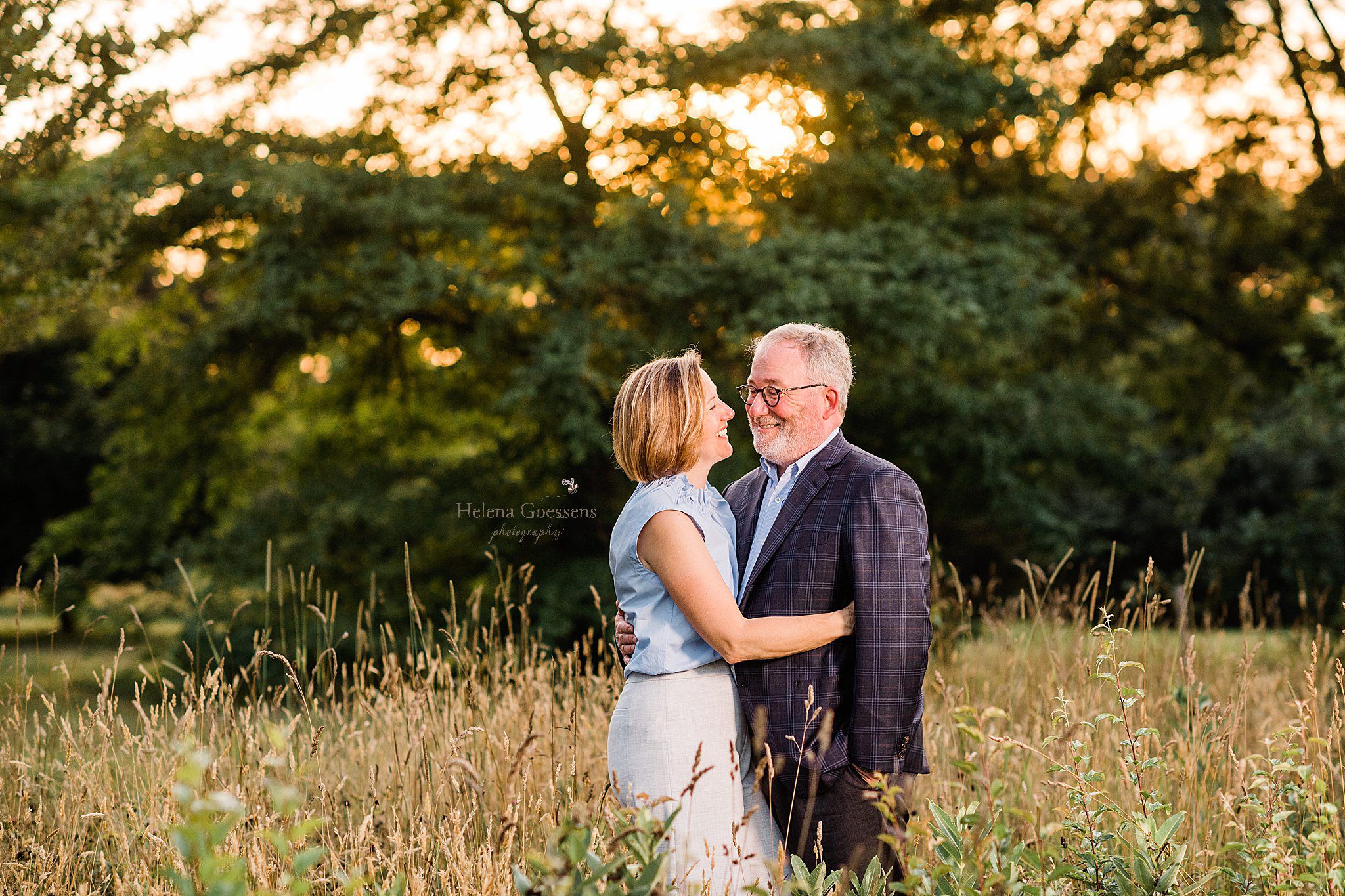 married couple embraces in the field at Arnold Arboretum