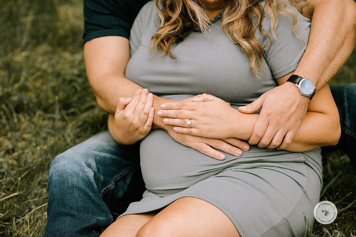 mom and dad place hands on mom's round belly during maternity session with Helena Goessens Photography
