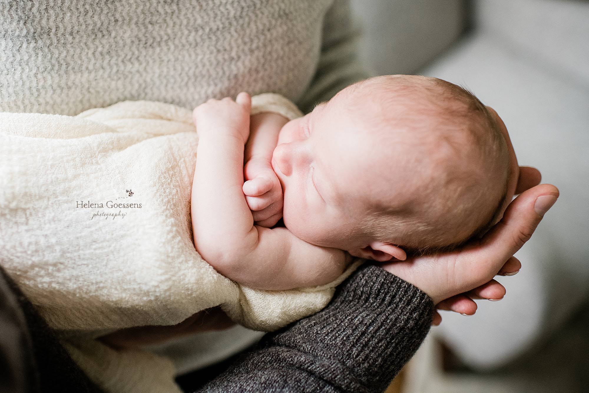 Helena Goessens Photography captures mom and dad holding new baby boy
