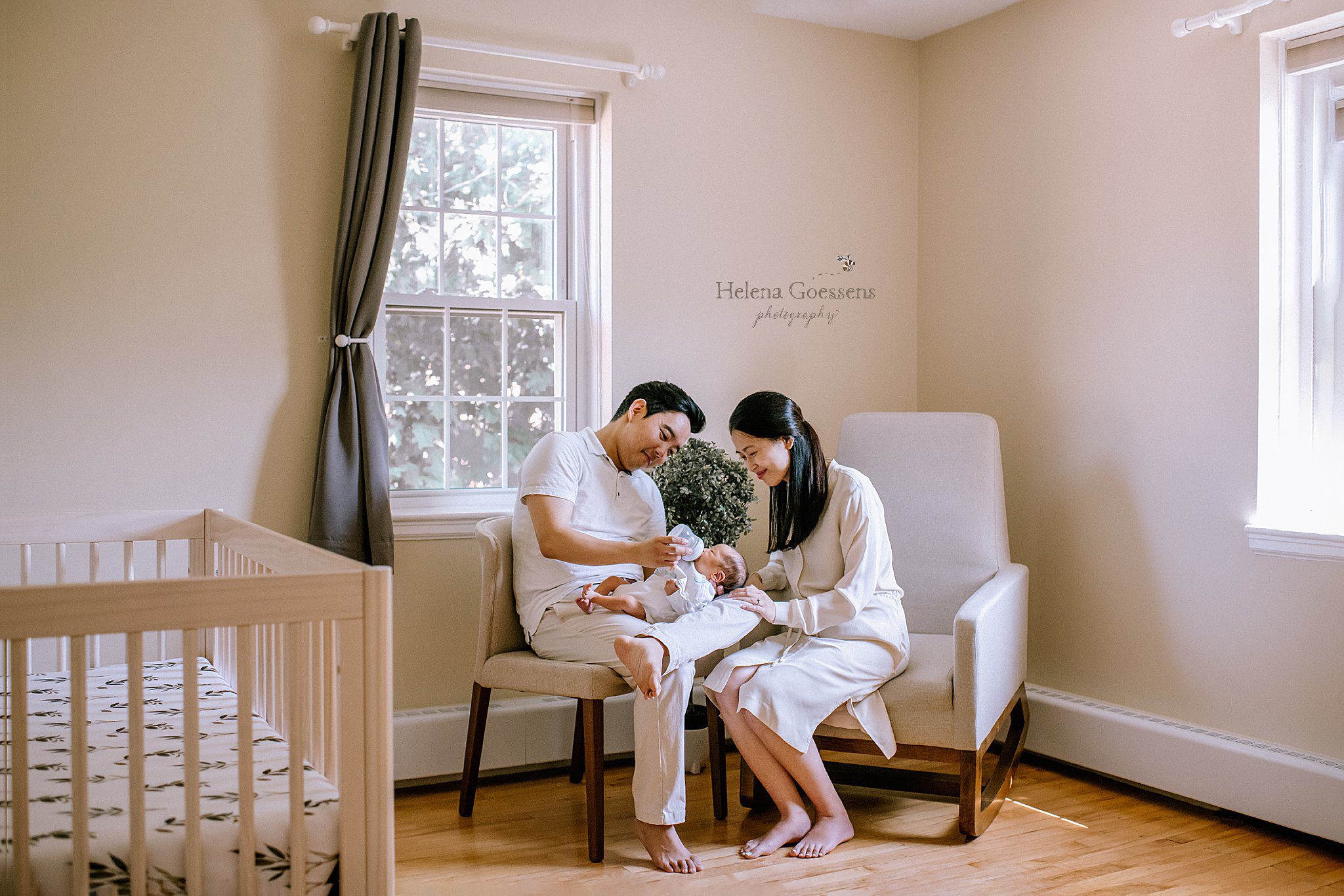dad feeds baby in nursery during Chestnut Hill lifestyle newborn session