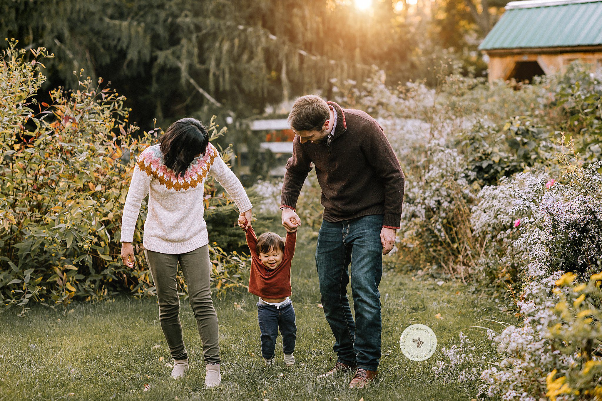 parents walk with toddler in backyard during fall family photos