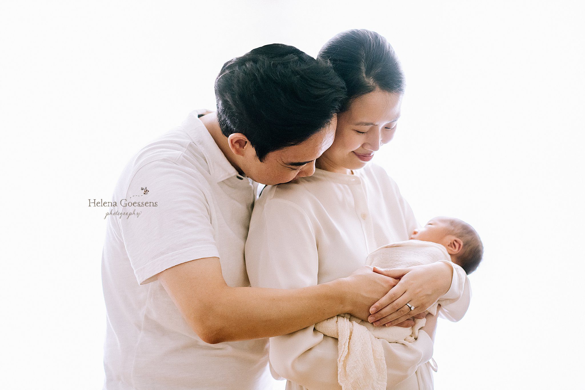 dad hugs mom and baby during MA newborn session at home