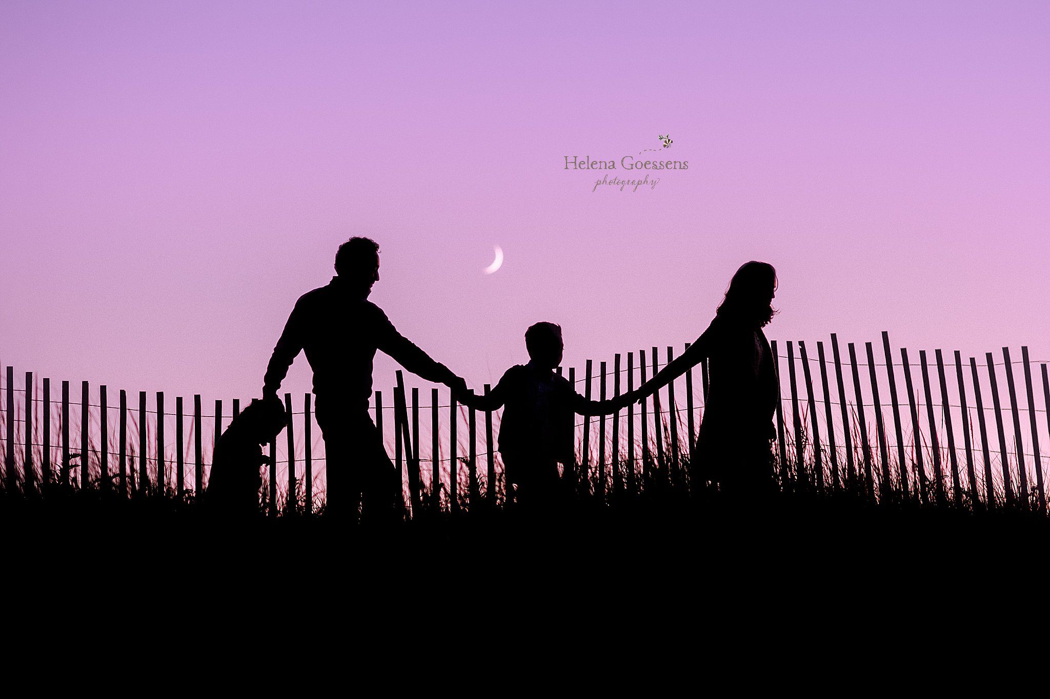 family walks along fence line at Rexhame Beach