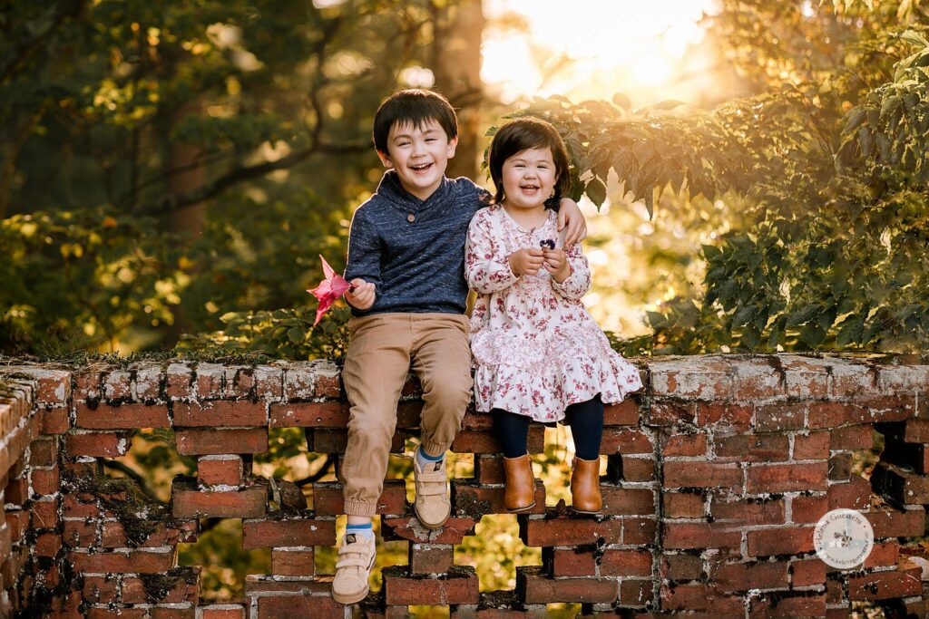 Helena Goessens Photography captures siblings sitting on brick wall at Bradley Estate