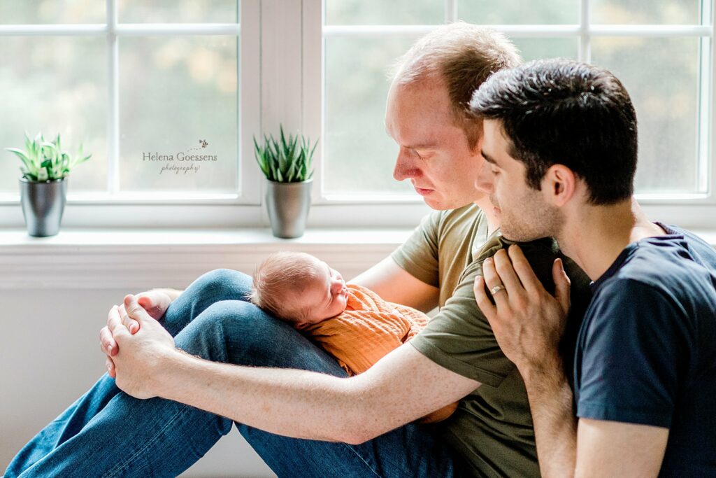 dads look at newborn baby boy during Needham MA lifestyle session
