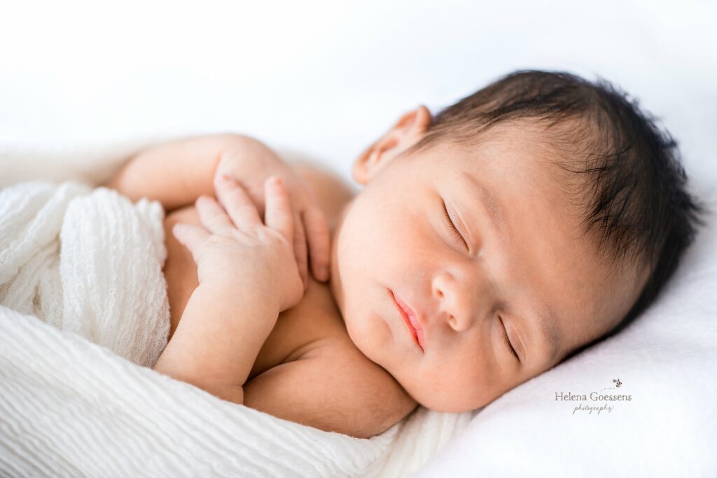 baby sleeps on white sheet during Jamaica Plains lifestyle newborn session 