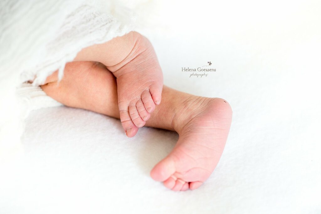 baby feet lay on white blanket during Jamaica Plains lifestyle newborn session at home 