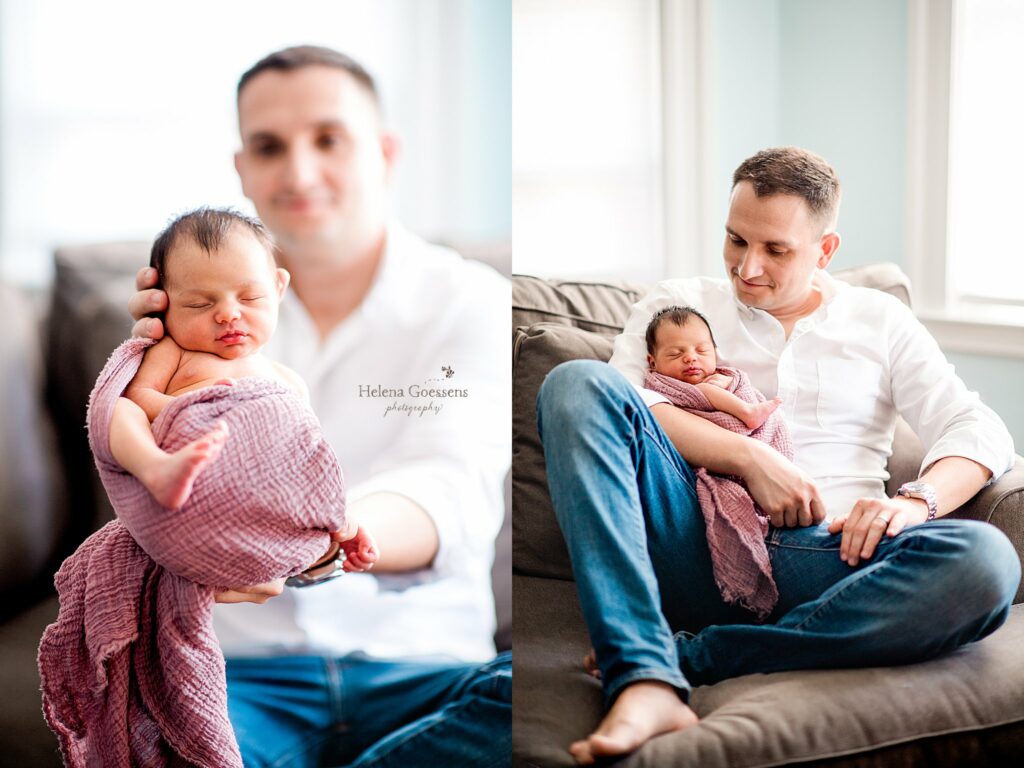 dad holds new baby girl in mauve wrap on couch during Jamaica Plains lifestyle newborn session 