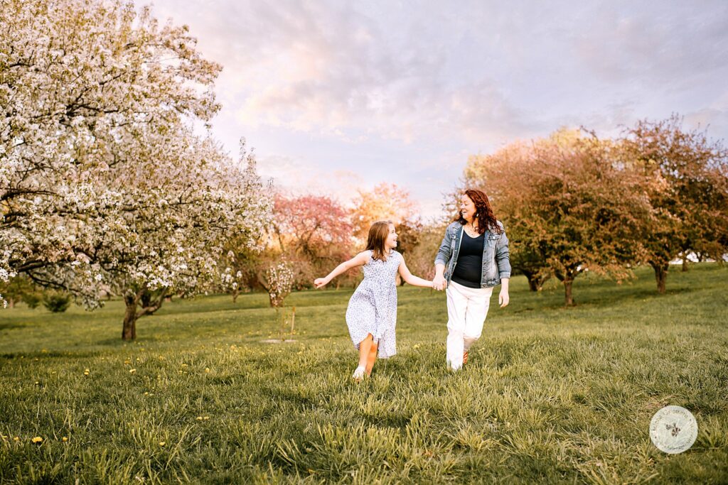mom runs with daughter through Arnold's Arboretum 