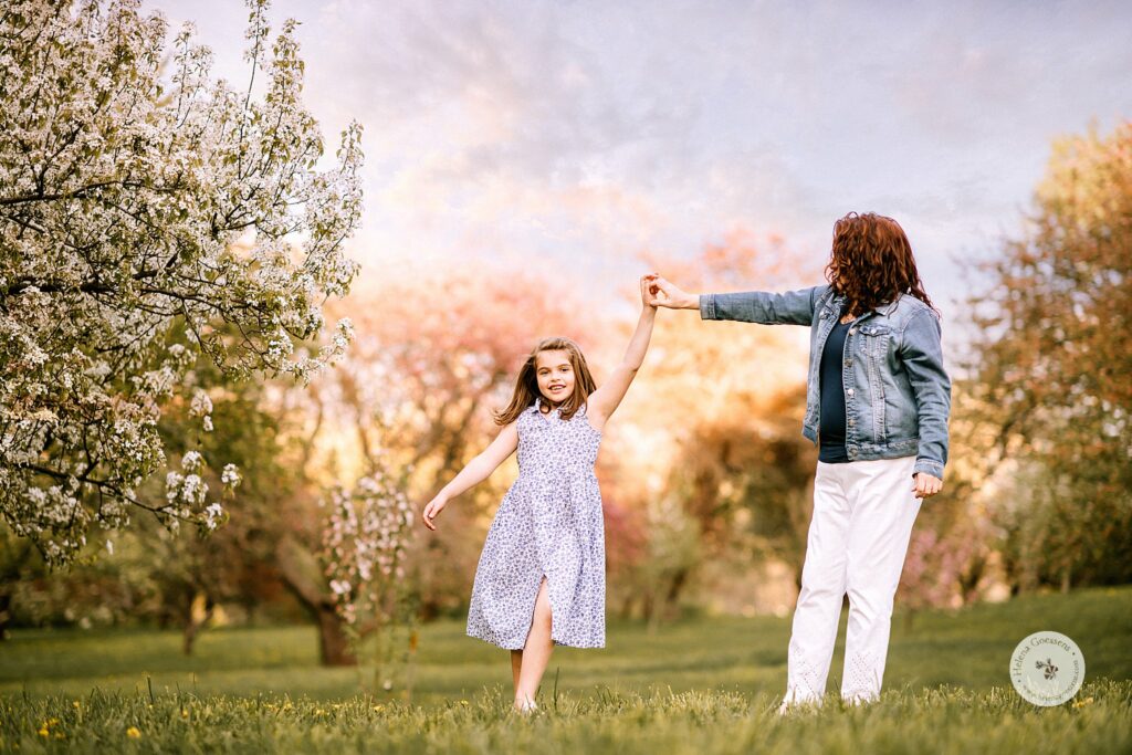 mom twirls young daughter during Peter's Hill family photos