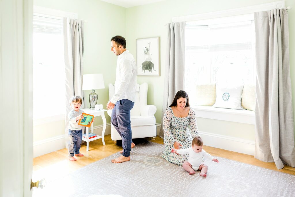 parents play with sons in nursery during Lifestyle Family Portraits in Weston MA